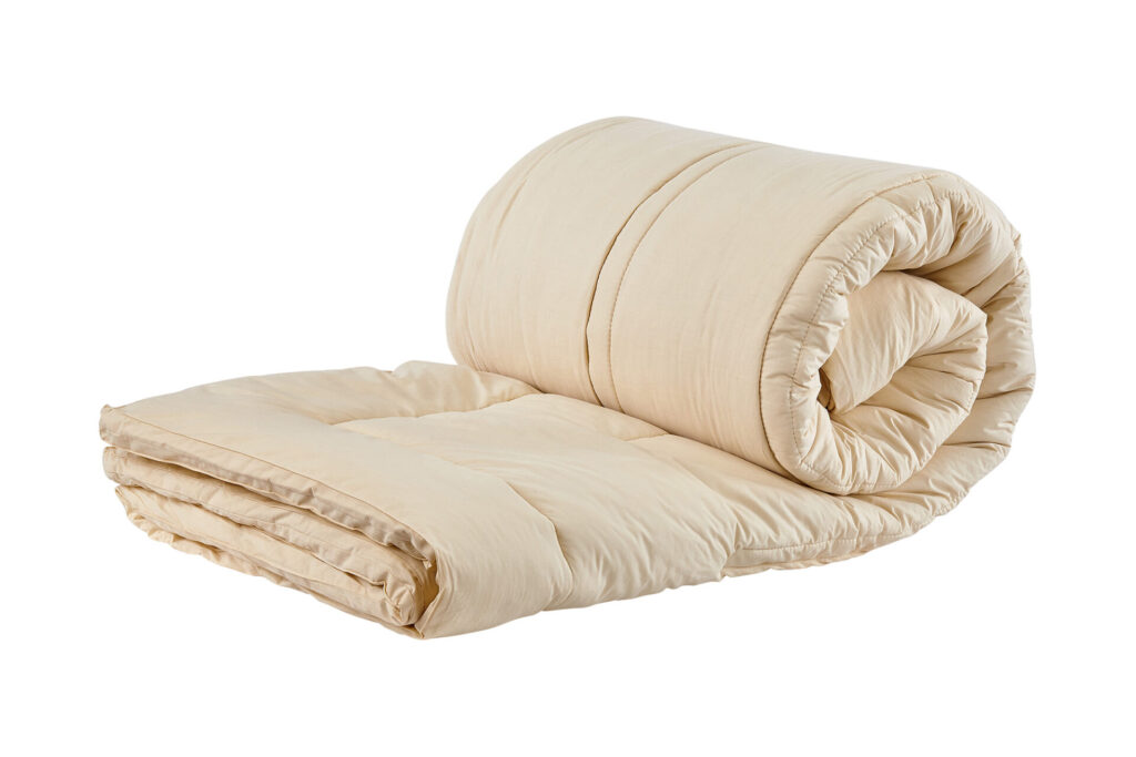 Ivory wool mattress topper rolled up 