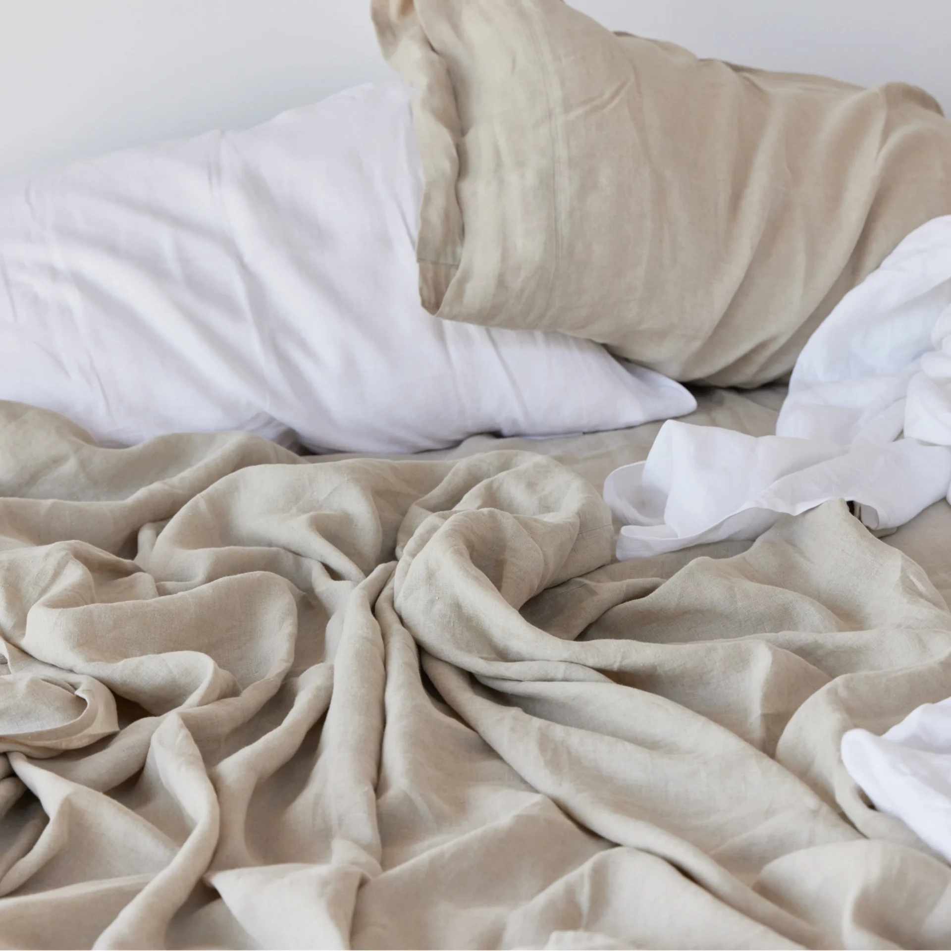 Avocado linen sheets and two pillows covered in Avocado linen pillowcases