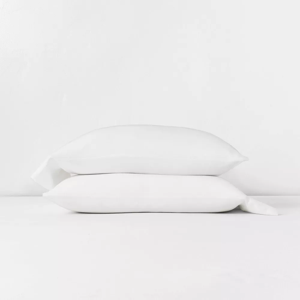 Two pillows covered in white Casaluna linen pillowcases