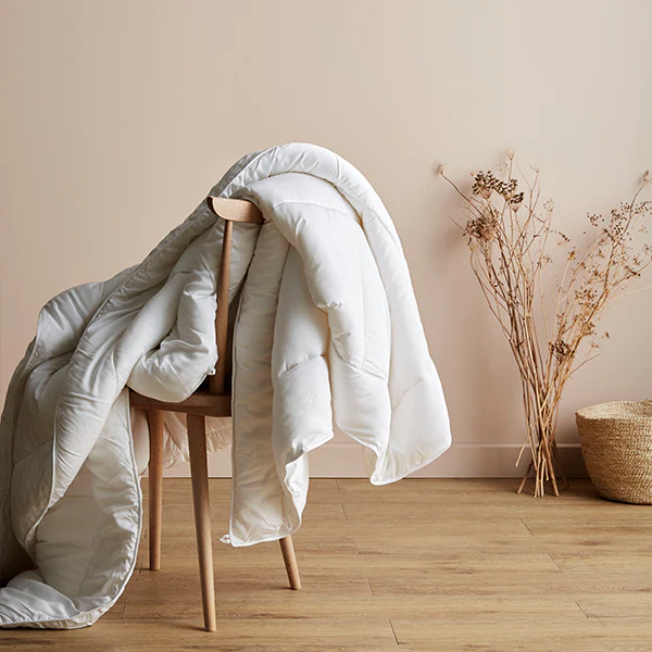 Ettitude Down Alternative Comforter draped over a chair