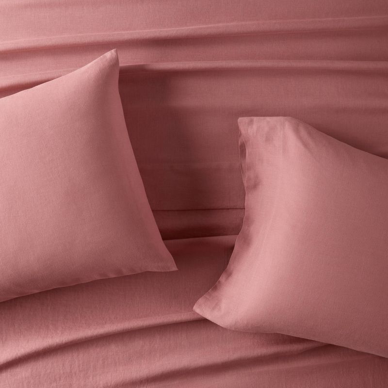 Hemp pillow case set from Target in rose pink on a bed 