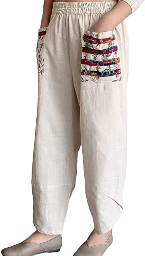 A woman wearing an off-white pair of linen harem pants with patterned pockets
