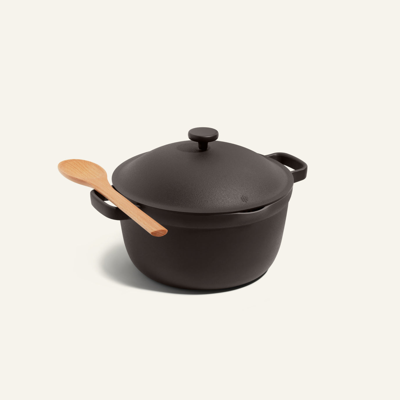 Our Place Perfect Pot Non Toxic Slow Cooker shown with a wooden spoon resting on one handle 