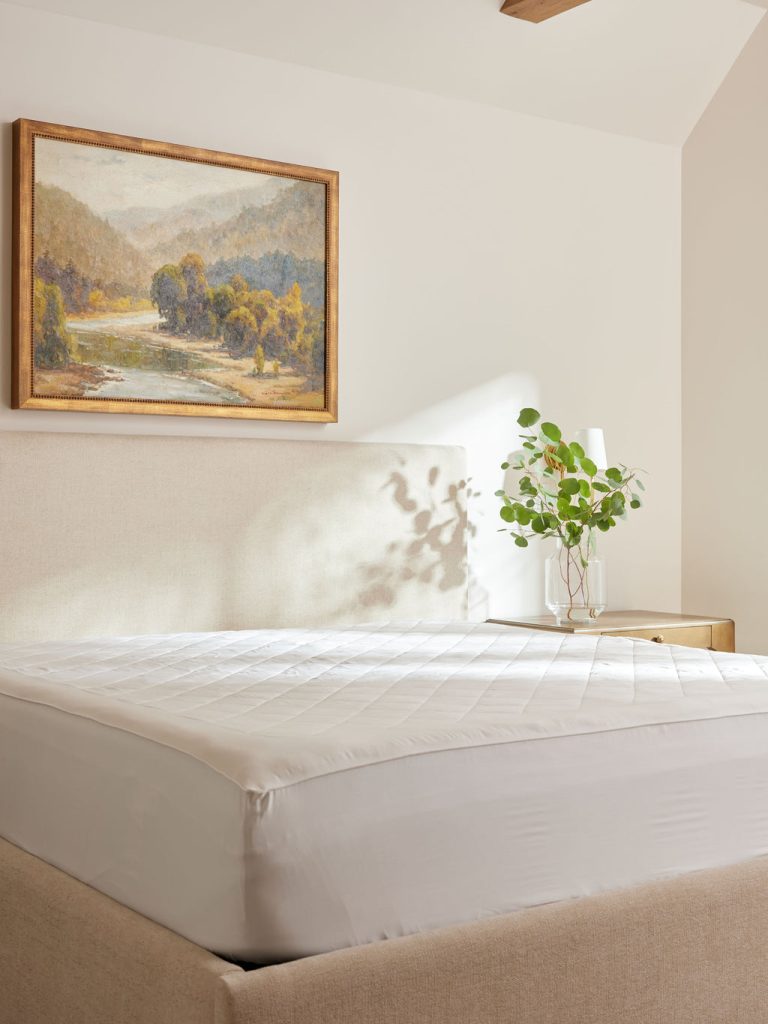 Cozy Earth’s Cooling Mattress Protector, on a bed