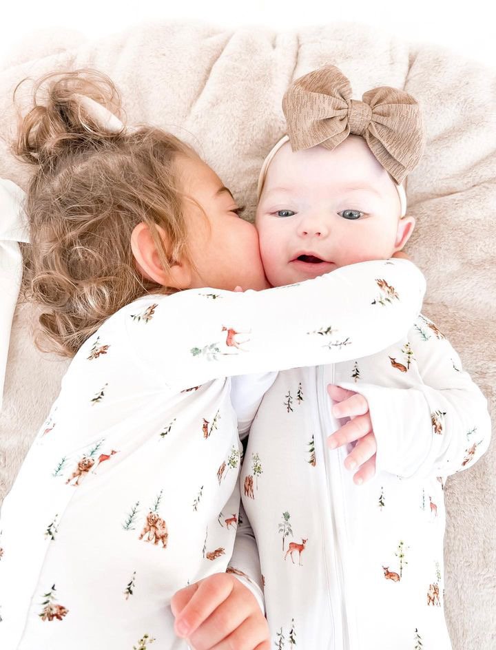 toddler explores playtime in the Wild Woods Toddler Pajamas, featuring delightful brown bears, deer, and pine trees, perfect for adventurous little ones.