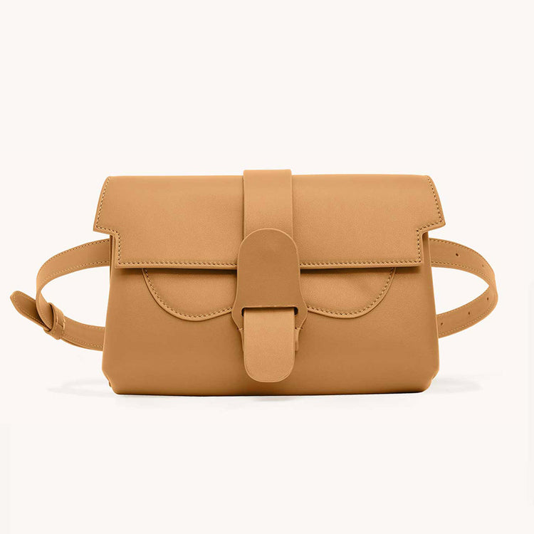 Senreve Aria Belt Bag in saddle-colored cactus leather, featuring a front slip pocket, adjustable strap, and versatile, stylish design.