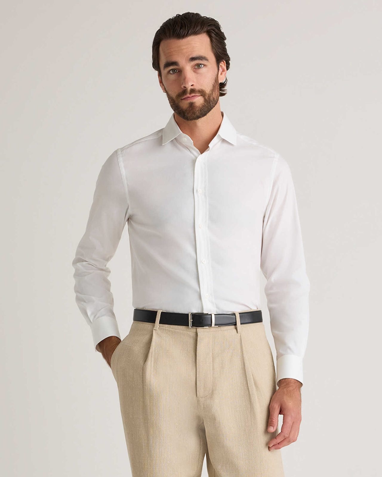 Man wearing a white organic cotton shirt from Quince, a sustainable clothing brand known for its eco-friendly materials and stylish designs