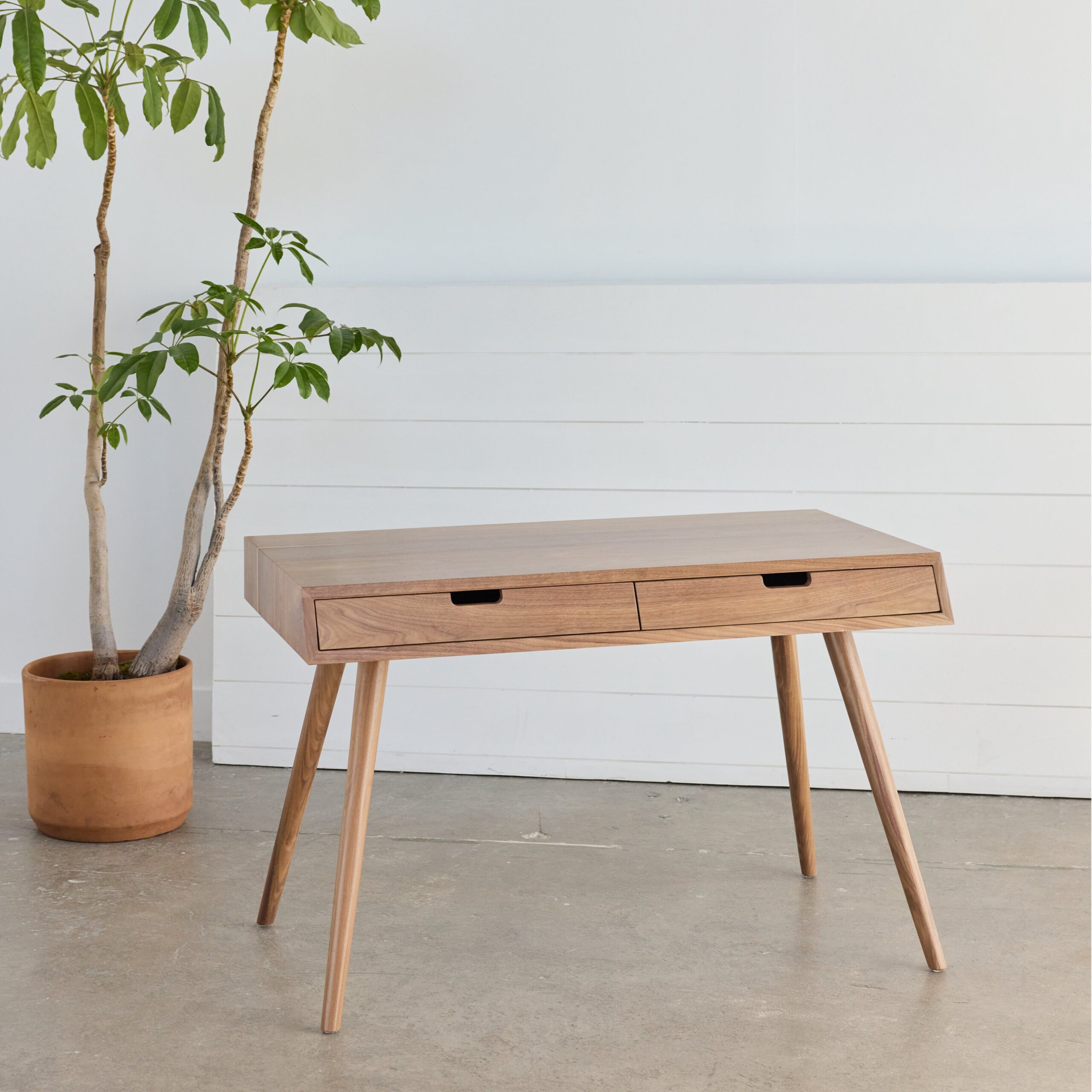 Enhance your home office with our Walnut Mid-Century Modern Desk – sustainable, stylish, and perfect for eco-conscious workspaces.
