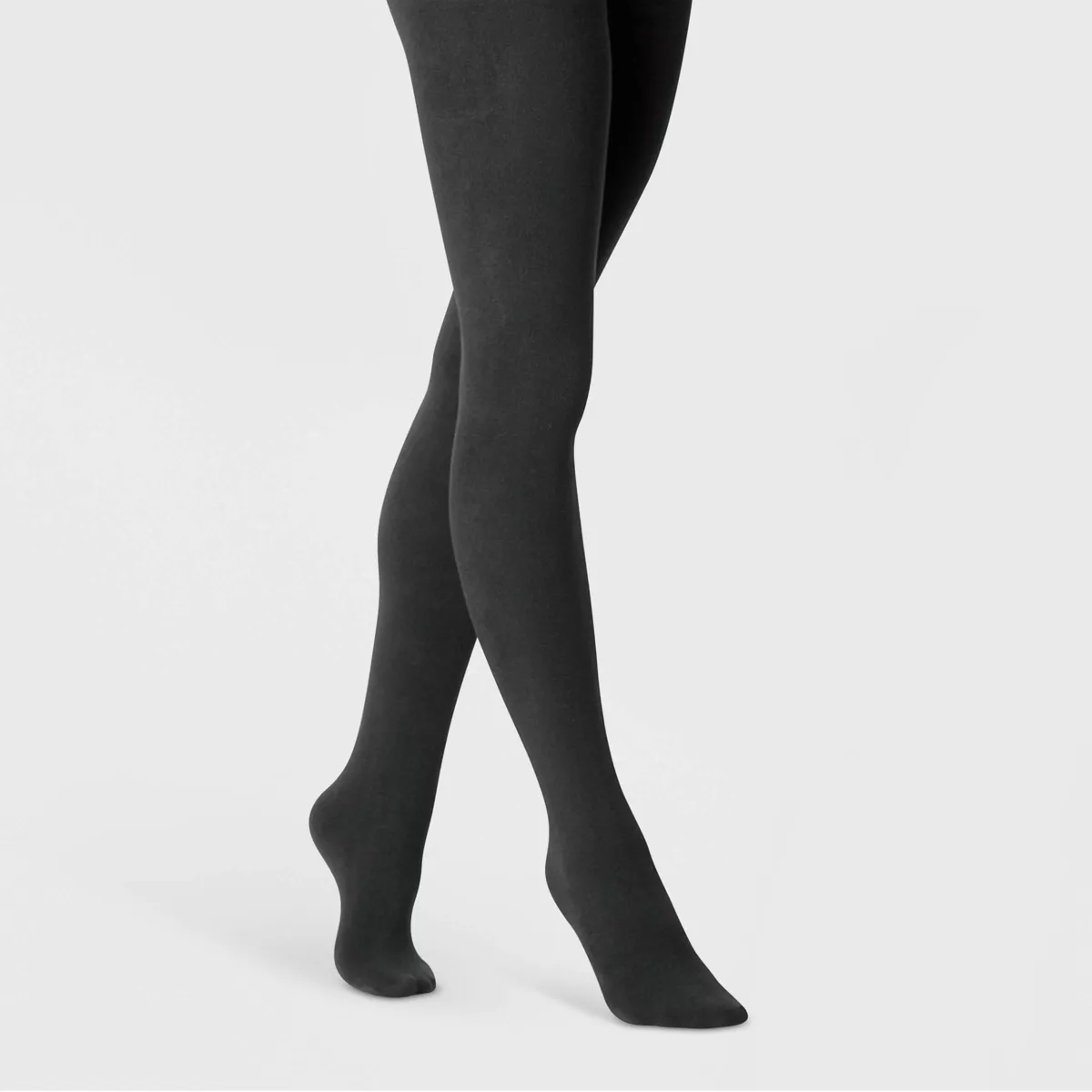 A woman wearing black cotton tights with fleece lining from A New Day