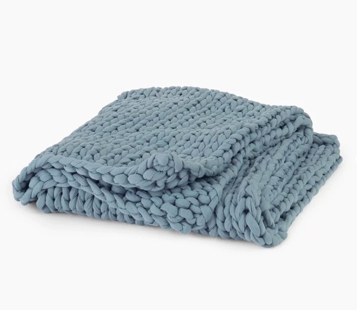 A folded blue Bearby tree napper eucalyptus blanket