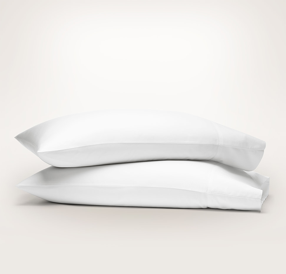 Two pillows covered in Boll & Branch signature hemmed cotton pillowcases
