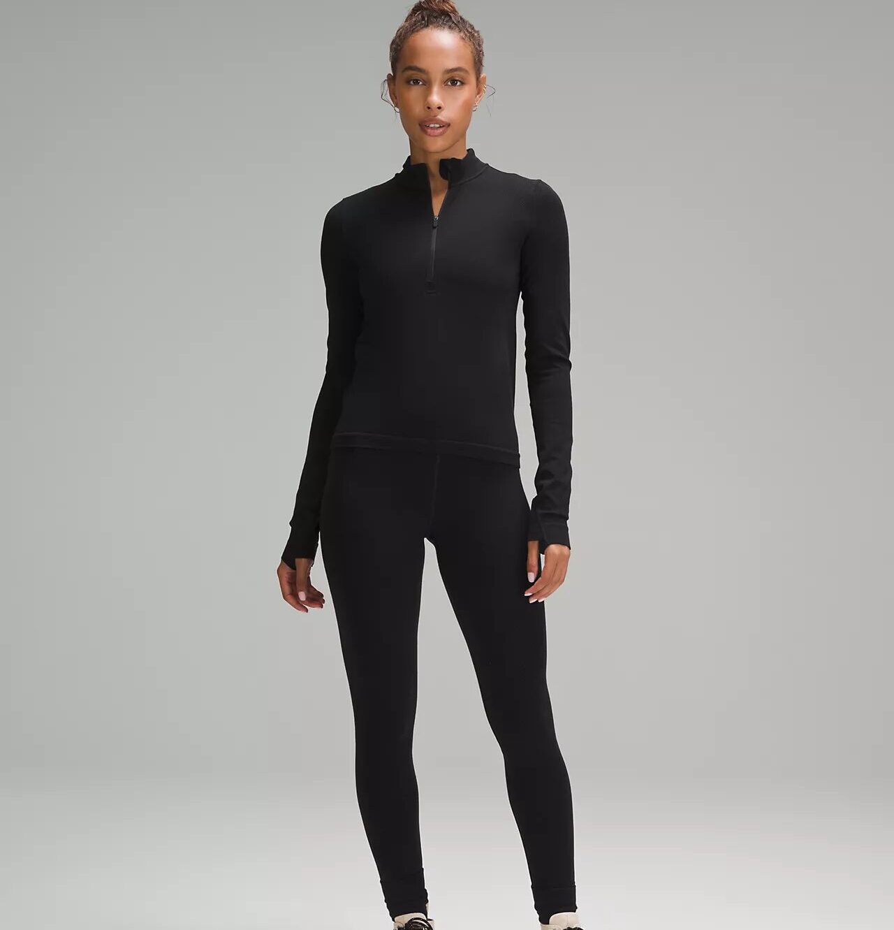 A woman wearing a matching black set from Lululemon