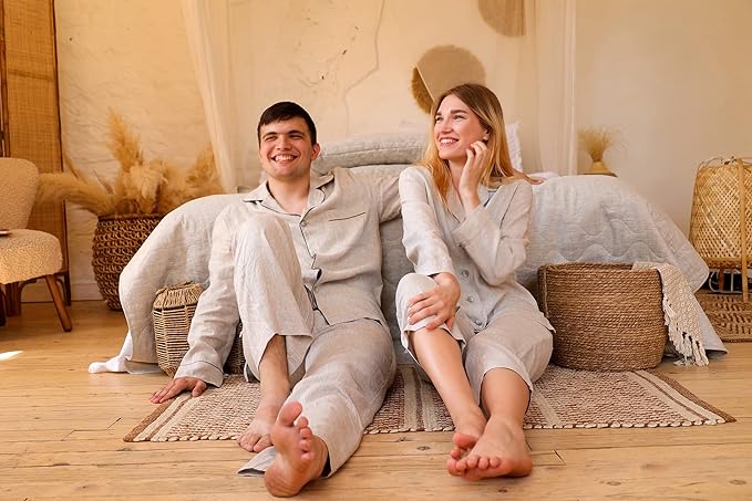 A man and qwoman sitting on the floor wearing hemp pajamas