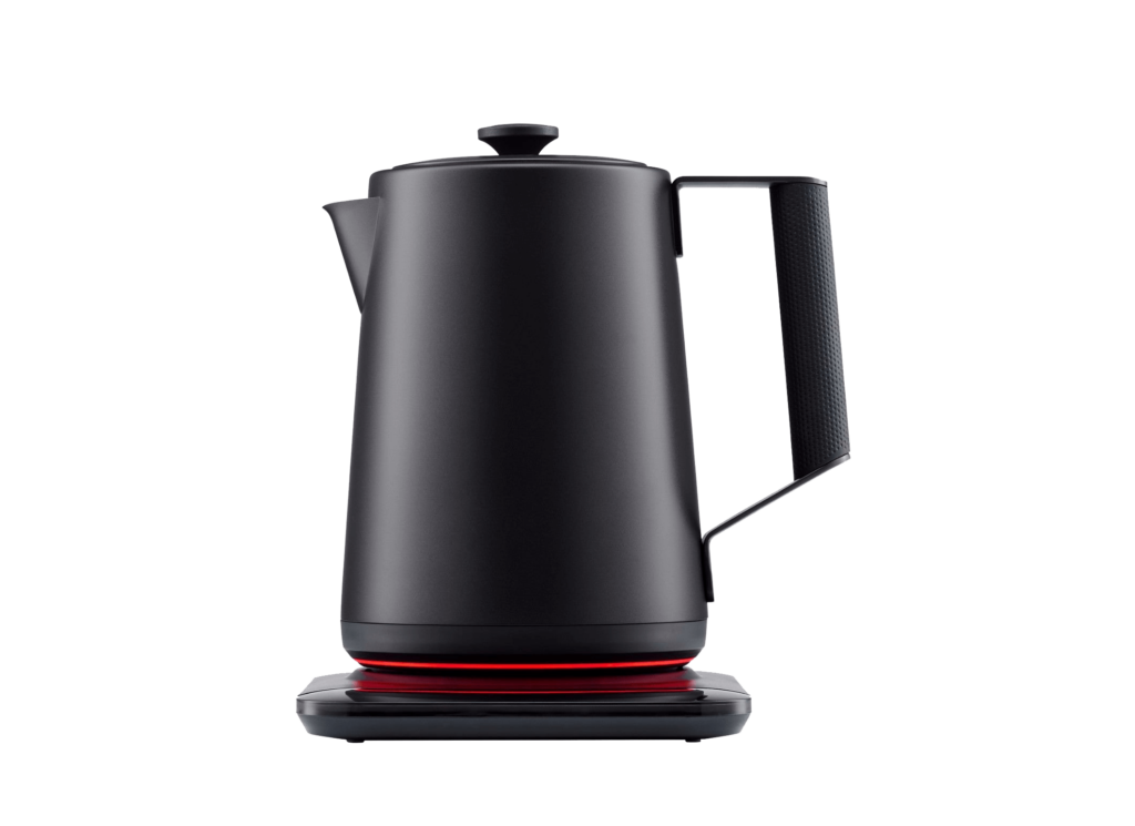 Sleek, black electric kettle with a red illuminated base, resting on a gray surface.