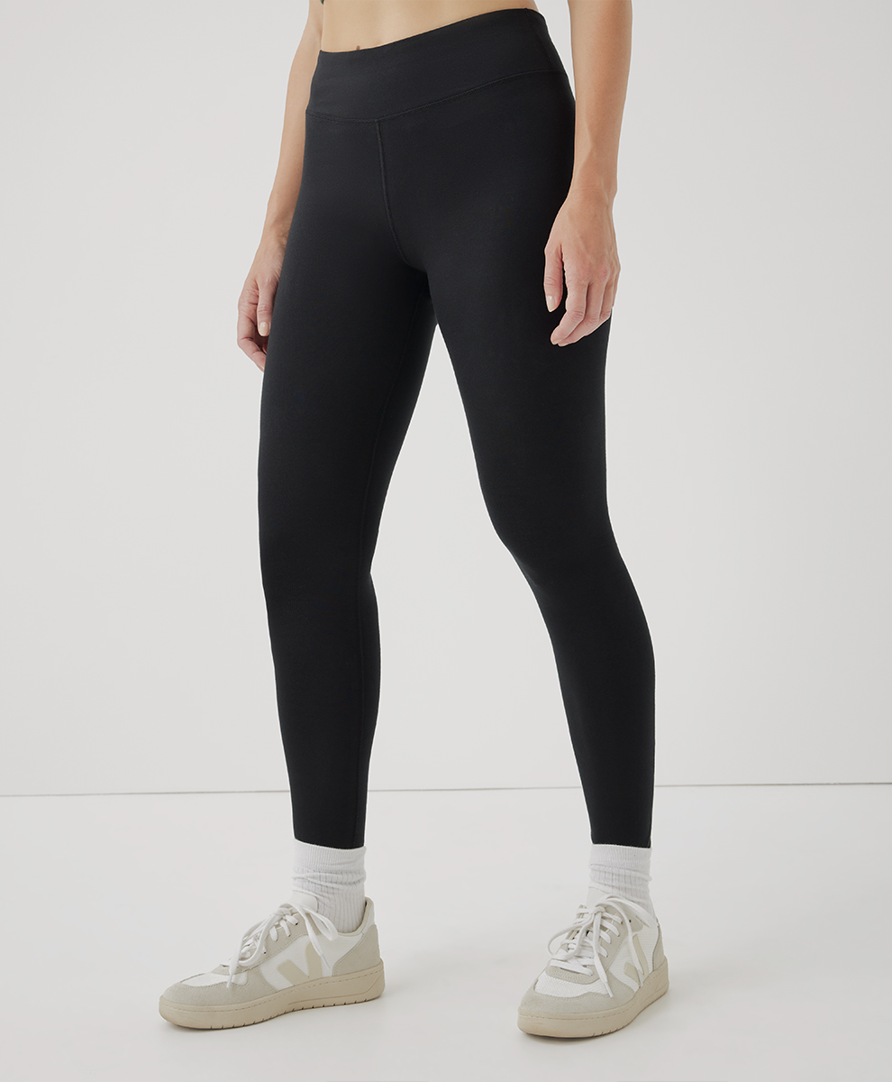 woman wearing black tights from pact with white socks and white sneakers