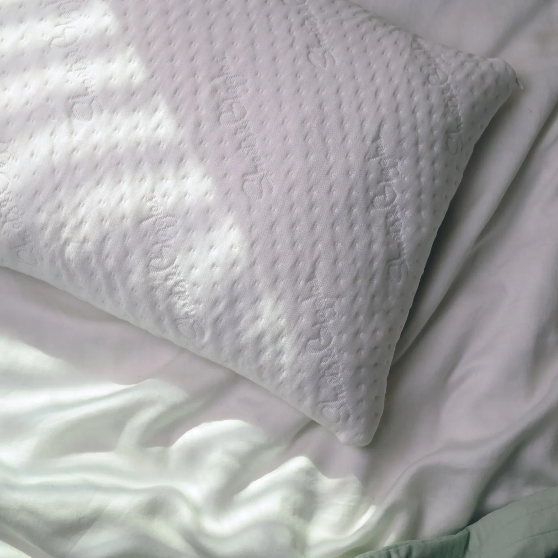 Sheets & Giggles adjustable eucalyptus pillow laying on a bed