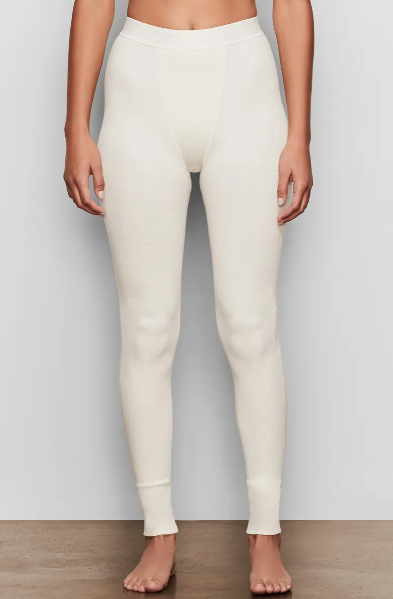 A woman wearing a white pair of Skims cotton tights