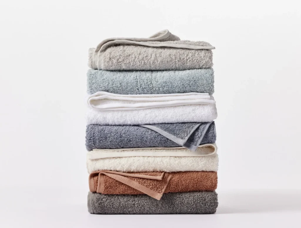 A stack of seven colorful organic cotton towels from Coyuchi