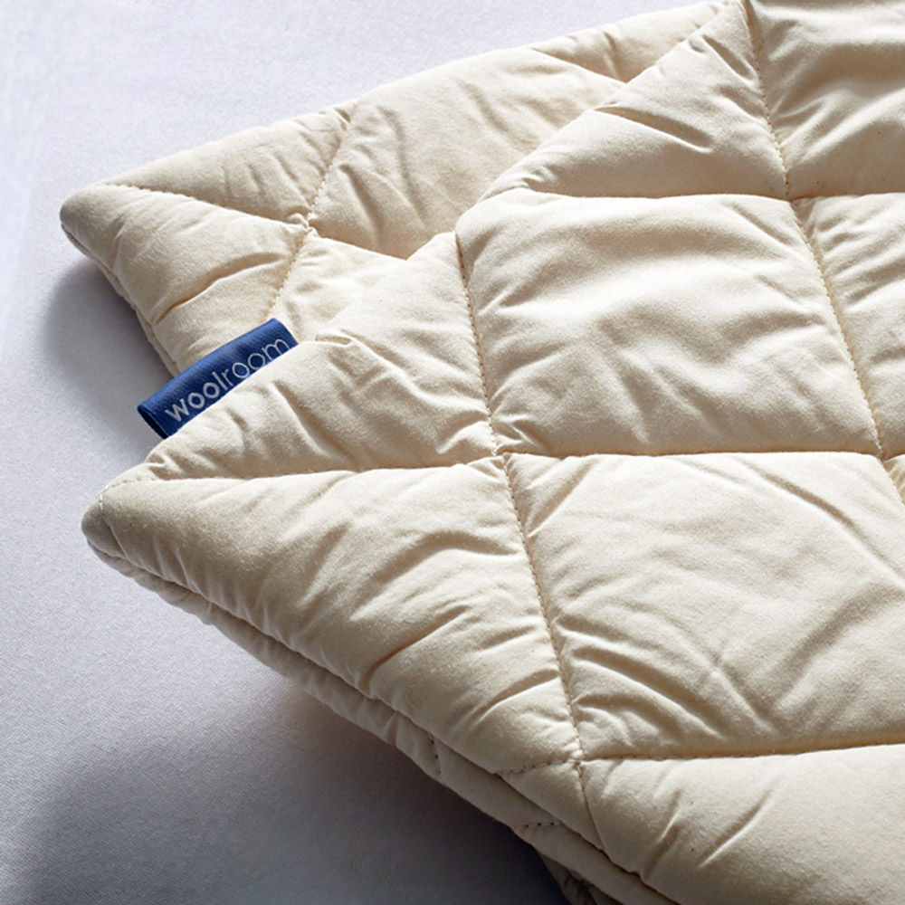 A close up of the Woolroom organic washable wool pillow cover