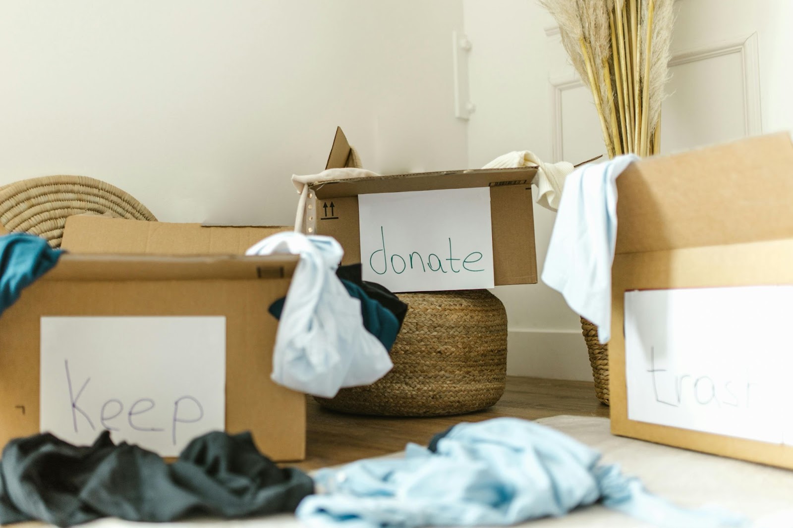 A decluttering system with three labeled boxes: Keep, Donate, Trash.