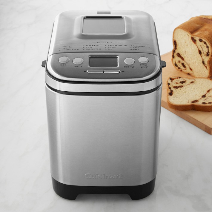 Cuisinart non-toxic bread machine with stainless steel body beside sliced cinnamon raisin bread.