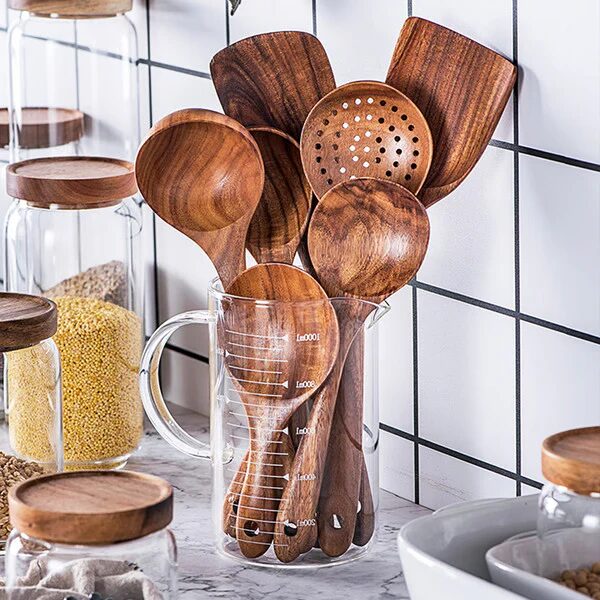 Non-toxic wooden kitchen utensils in a glass jar, showcasing eco-friendly, chemical-free cooking tools.