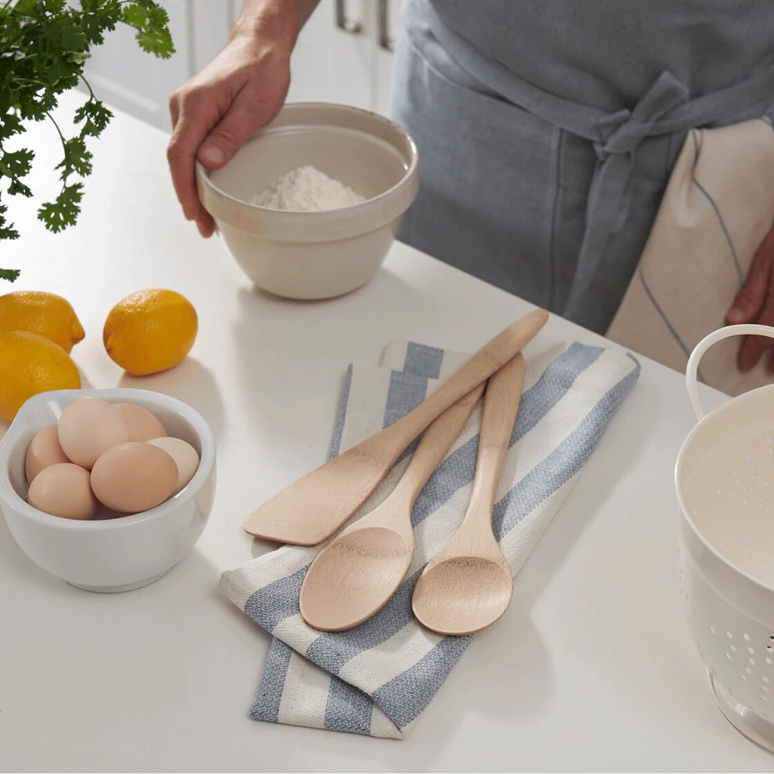 A 3-piece set of wooden utensils from Bambu on a kitchen counter with baking materials