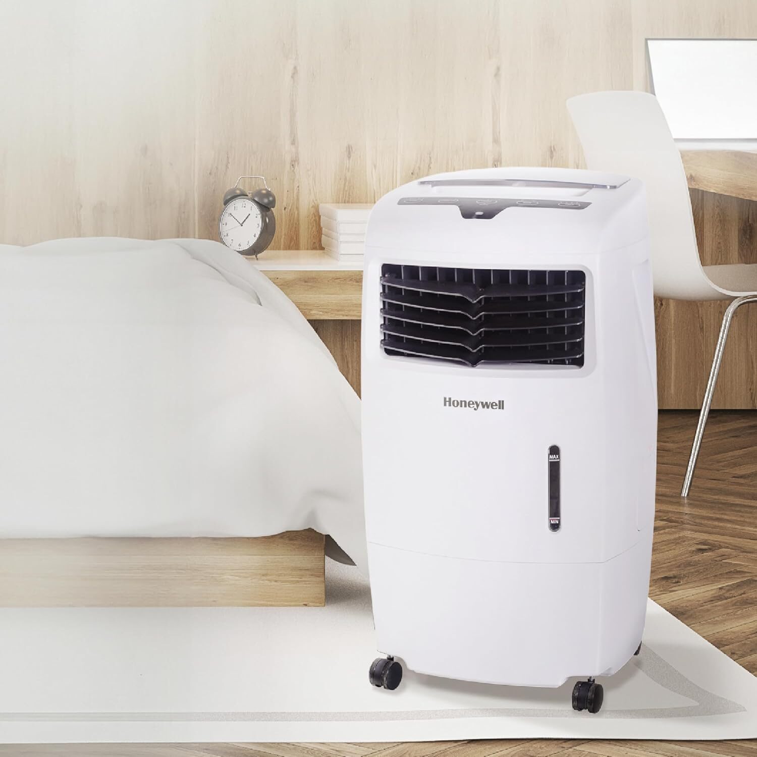 A Honeywell brand evaporative air cooler fan in a bedroom